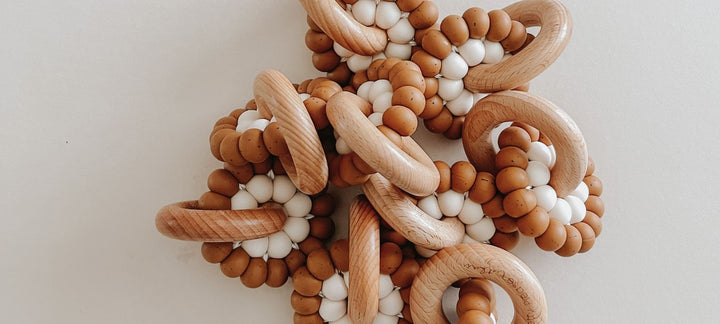 Pretty Please Teethers -Reed Teething ring - silicone & wood rattle We incorporate wood into our teethers because the hardness of the beechwood helps relieve that pressure on extremely aching gums and help budding teeth pop through. 